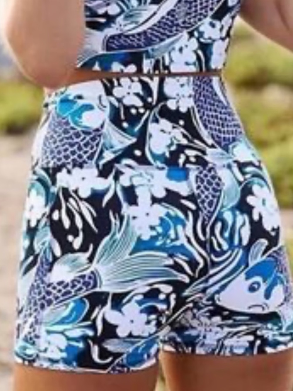 NWOT Free People Movement Never Better Run Shorts in a Blue Koi Fish print.